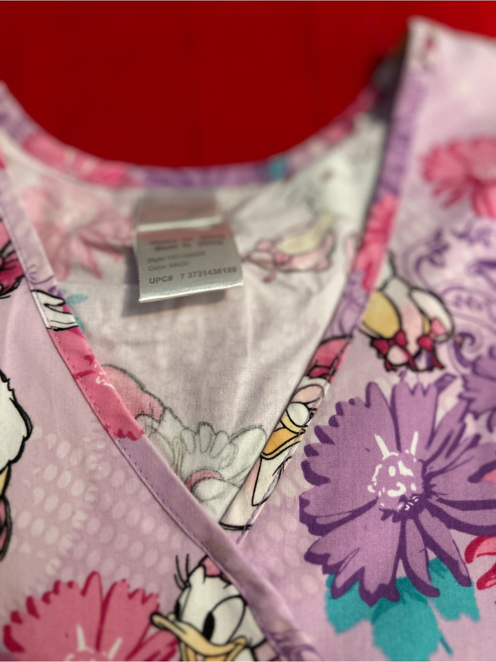 Disney Daisy Duck Lavender and Pink Floral scrub top